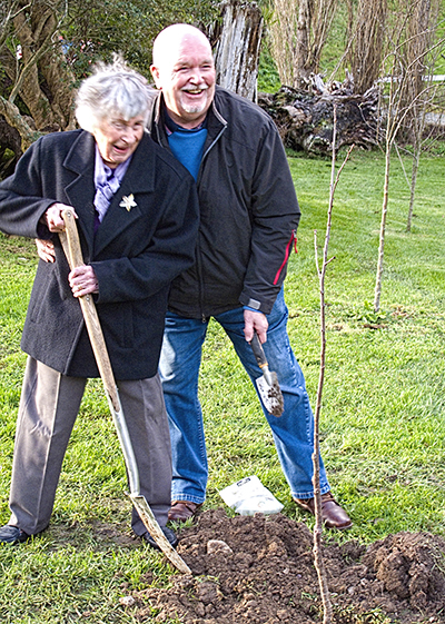 Jean and Adrian Liner planting Montmorency cherry tree
